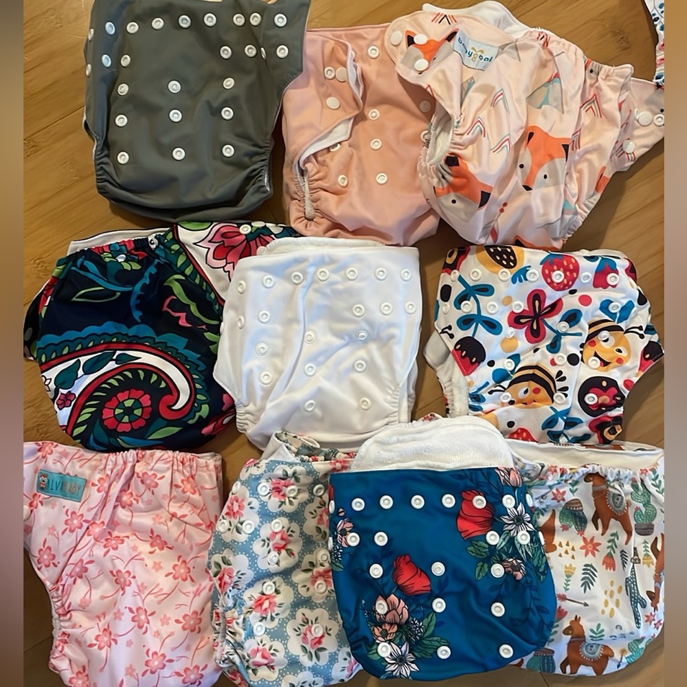 NWOT. 24 Cloth Diapers + inserts + reusable pail liners